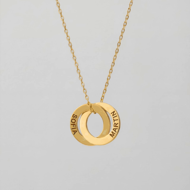 Close-up of the gold Amity necklace with three linked rings and example names.