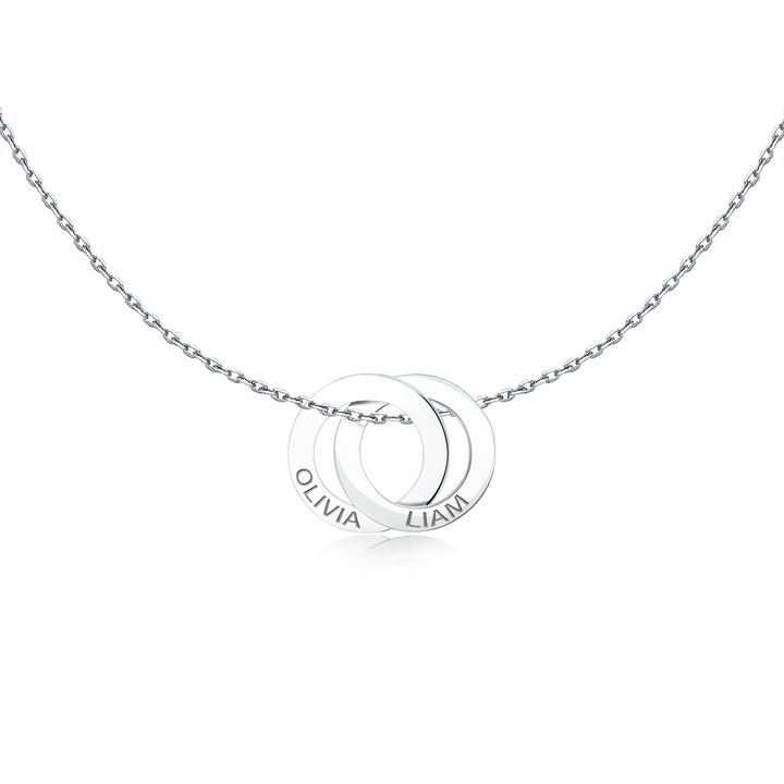 Close-up of the interlocking Amity Necklace rings engraved with names
